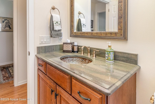 bathroom featuring vanity and hardwood / wood-style floors