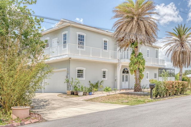 view of front of home featuring a garage and a balcony