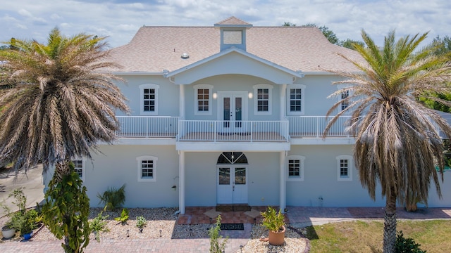 rear view of house featuring french doors and a balcony