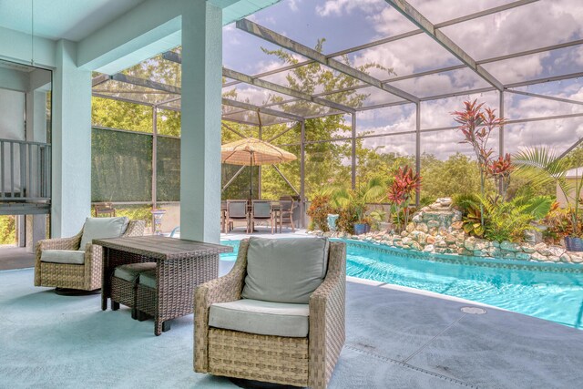 pool at dusk with a patio area and glass enclosure