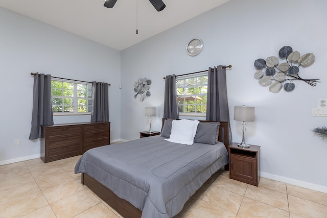 bedroom with ceiling fan, high vaulted ceiling, and light tile patterned floors