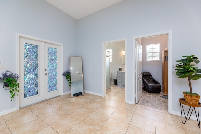 entrance foyer featuring light tile patterned floors and french doors