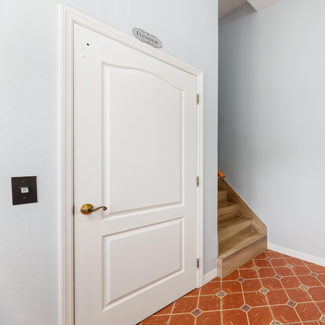 stairs featuring tile patterned floors