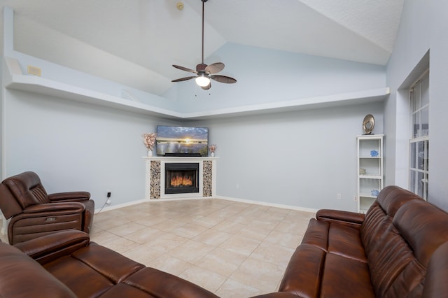 tiled living room featuring ceiling fan, lofted ceiling, and a tile fireplace