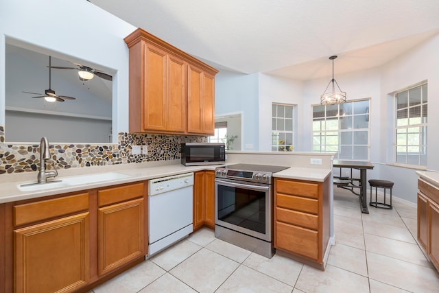 kitchen with sink, dishwasher, tasteful backsplash, stainless steel electric stove, and kitchen peninsula