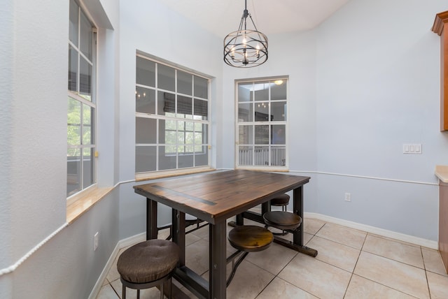 dining room with a chandelier and light tile patterned floors