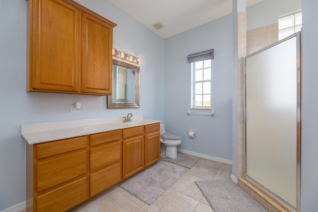 bathroom with vanity, toilet, a shower with shower door, and tile patterned flooring