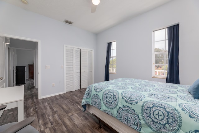 bedroom with a closet, dark hardwood / wood-style floors, and ceiling fan