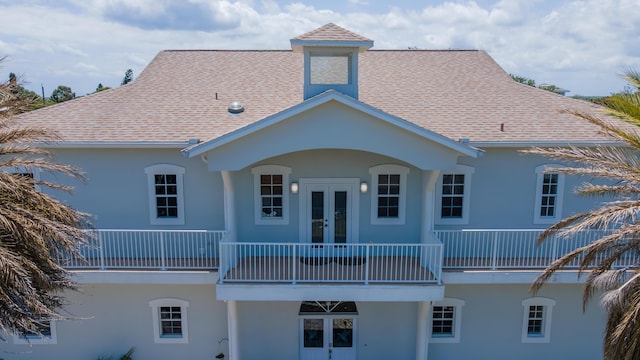 rear view of property with french doors and a balcony