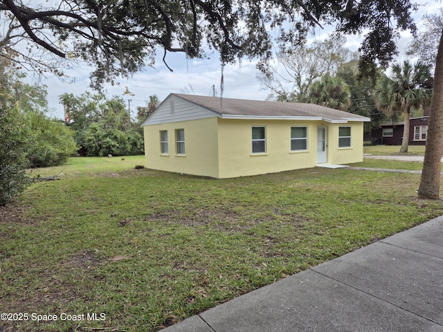 view of home's exterior with a lawn