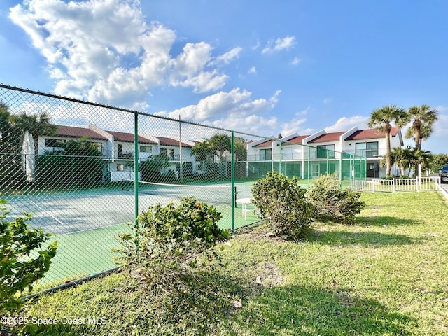 view of tennis court with a lawn