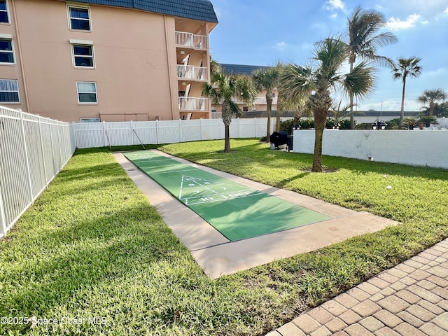 view of home's community featuring a lawn