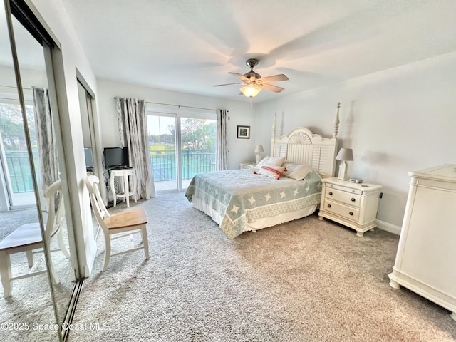 carpeted bedroom with access to exterior and ceiling fan