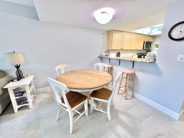 dining room with a textured ceiling