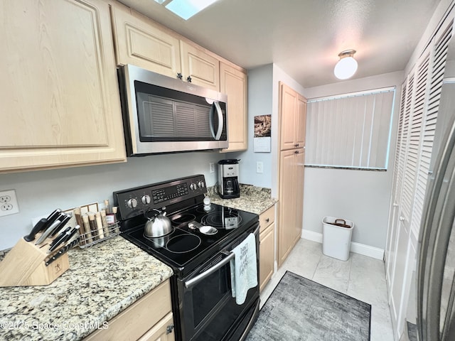 kitchen featuring electric stove, light stone countertops, and light brown cabinets