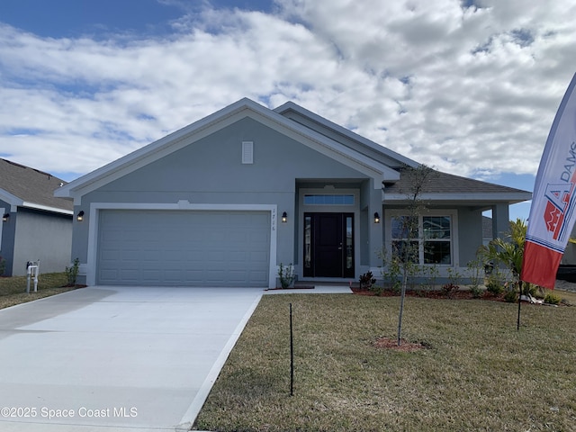 view of front facade with a garage and a front lawn