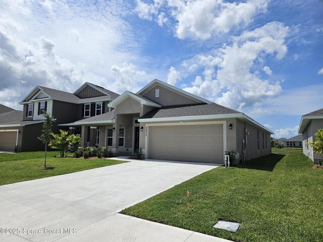 2472 Carrick St NW, Palm Bay, FL 32907 - view of front of property with stucco siding, a garage, driveway, and a front yard