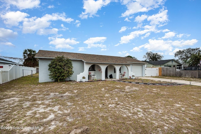 single story home with a garage and a front lawn