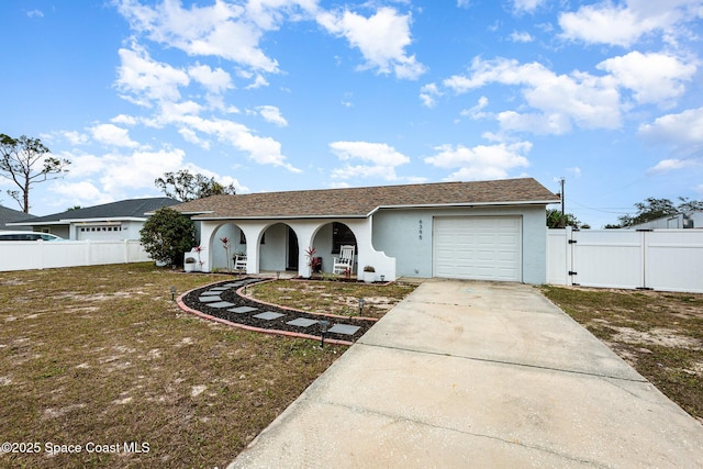 ranch-style home with a garage, a front yard, and covered porch