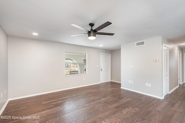 unfurnished room with dark wood-type flooring and ceiling fan