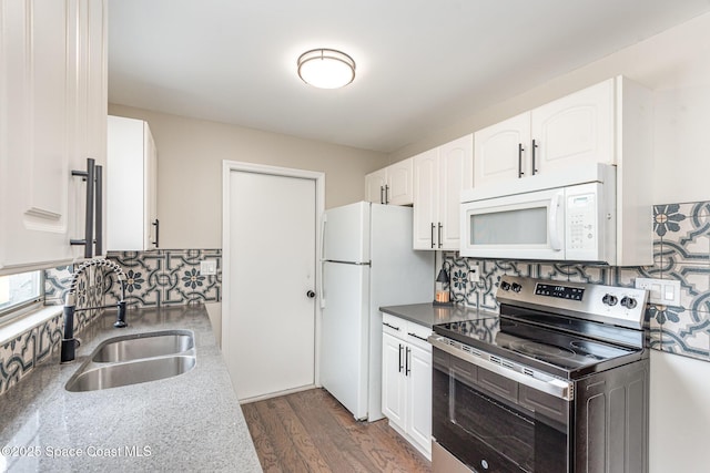 kitchen featuring white cabinetry, white appliances, sink, and tasteful backsplash