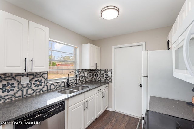 kitchen featuring sink, dark hardwood / wood-style floors, tasteful backsplash, white cabinets, and stainless steel dishwasher