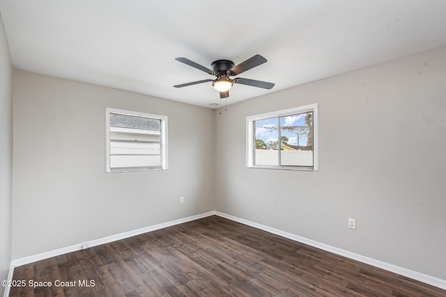 empty room with dark wood-type flooring and ceiling fan