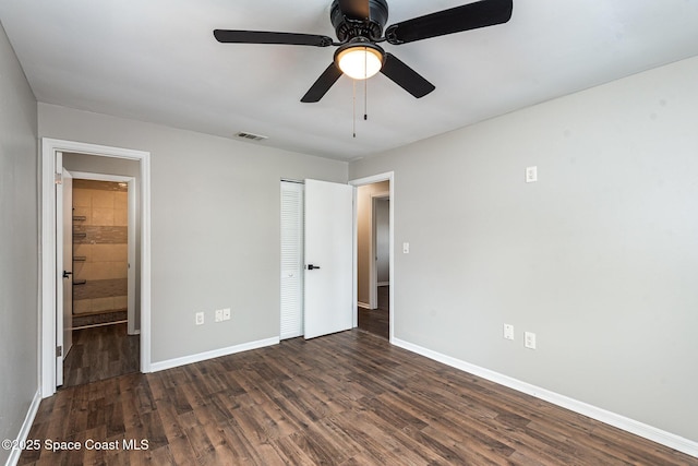 unfurnished bedroom featuring dark hardwood / wood-style floors, ceiling fan, and a closet