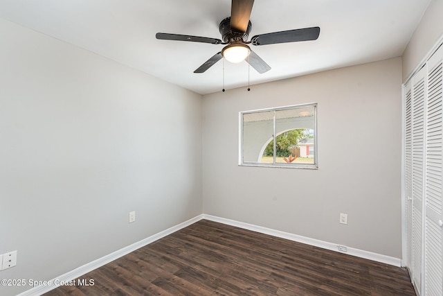 unfurnished bedroom with ceiling fan, dark hardwood / wood-style floors, and a closet