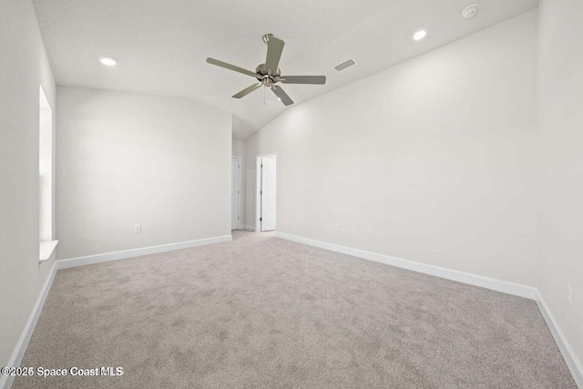 spare room with vaulted ceiling, carpet floors, and ceiling fan