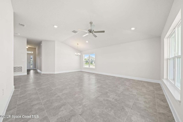 unfurnished room with lofted ceiling and ceiling fan with notable chandelier