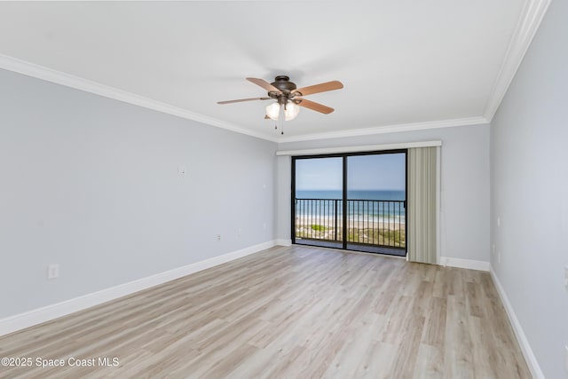 unfurnished room featuring light hardwood / wood-style flooring, ornamental molding, ceiling fan, and a water view