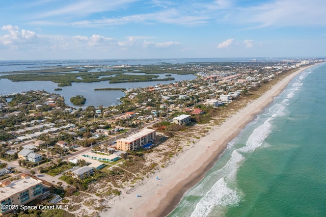 drone / aerial view featuring a water view and a beach view