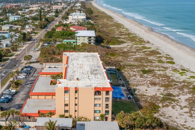 birds eye view of property featuring a beach view and a water view