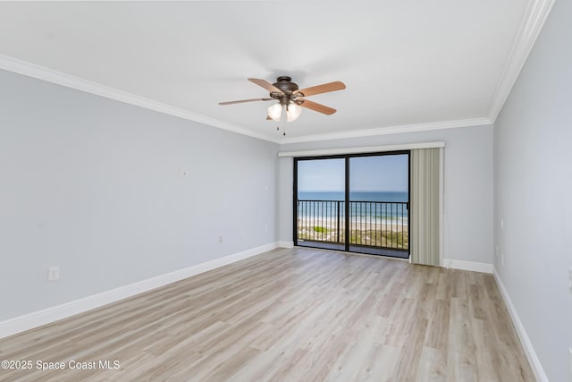 empty room featuring a water view, ceiling fan, ornamental molding, and light hardwood / wood-style floors