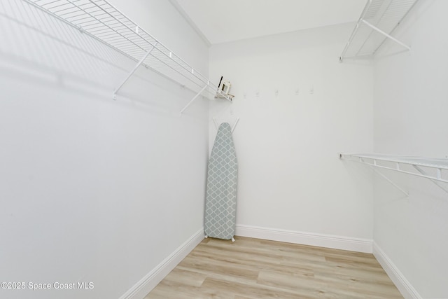 spacious closet featuring light hardwood / wood-style floors