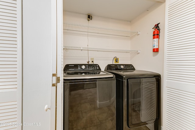 clothes washing area with separate washer and dryer