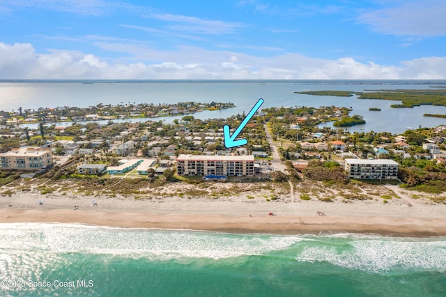 bird's eye view with a water view and a view of the beach