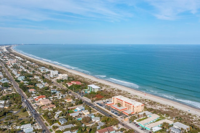 drone / aerial view with a beach view and a water view