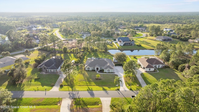 birds eye view of property with a water view and a residential view