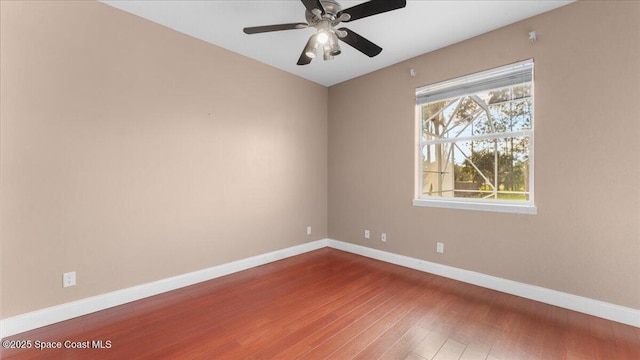 spare room with a ceiling fan, baseboards, and wood finished floors