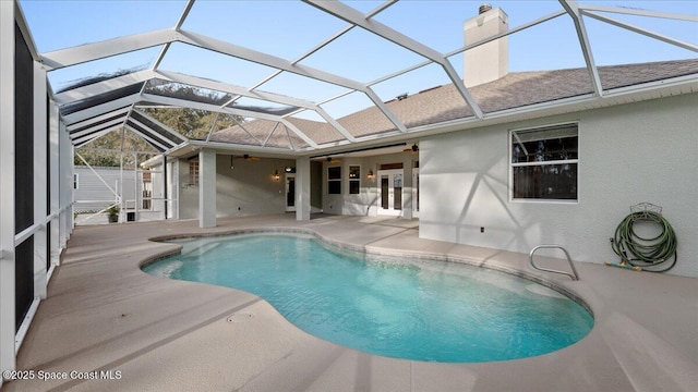 outdoor pool featuring ceiling fan, a patio area, and a lanai