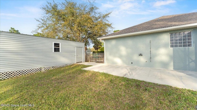 view of yard with an outbuilding and fence