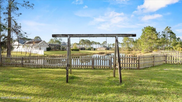 view of yard featuring a water view and fence