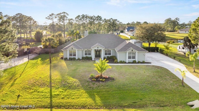 view of front of home with driveway, a front lawn, and fence