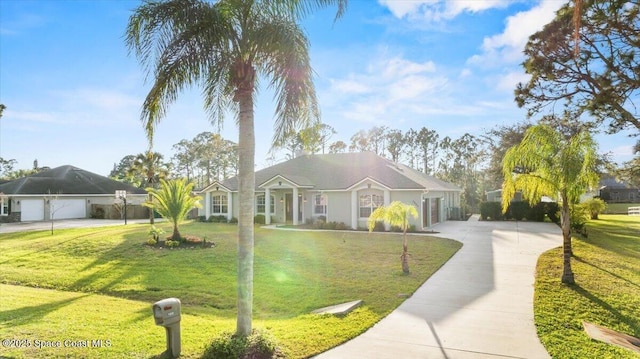 view of front of home with an attached garage, concrete driveway, and a front yard