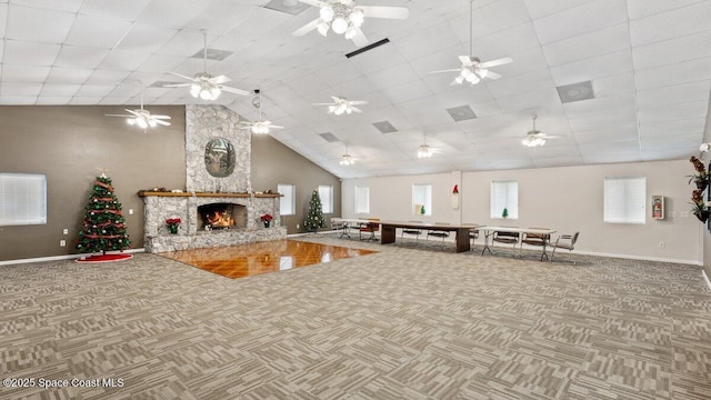 interior space featuring carpet, a fireplace, high vaulted ceiling, and baseboards