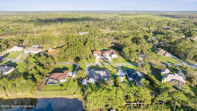 aerial view featuring a forest view and a water view