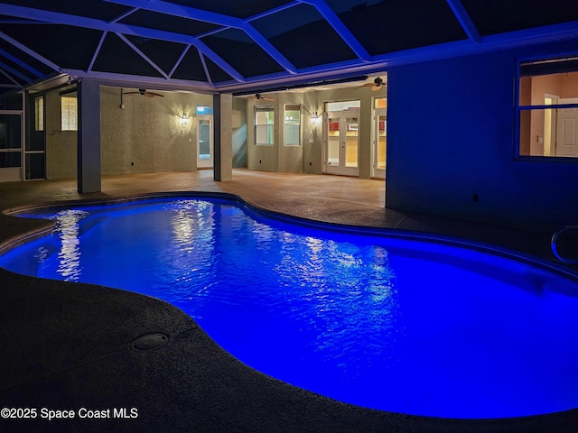 outdoor pool with a patio area, glass enclosure, a ceiling fan, and french doors