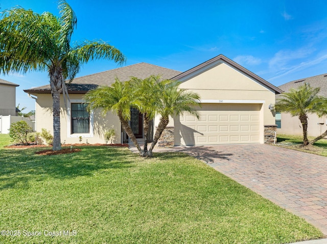 single story home featuring a garage and a front yard